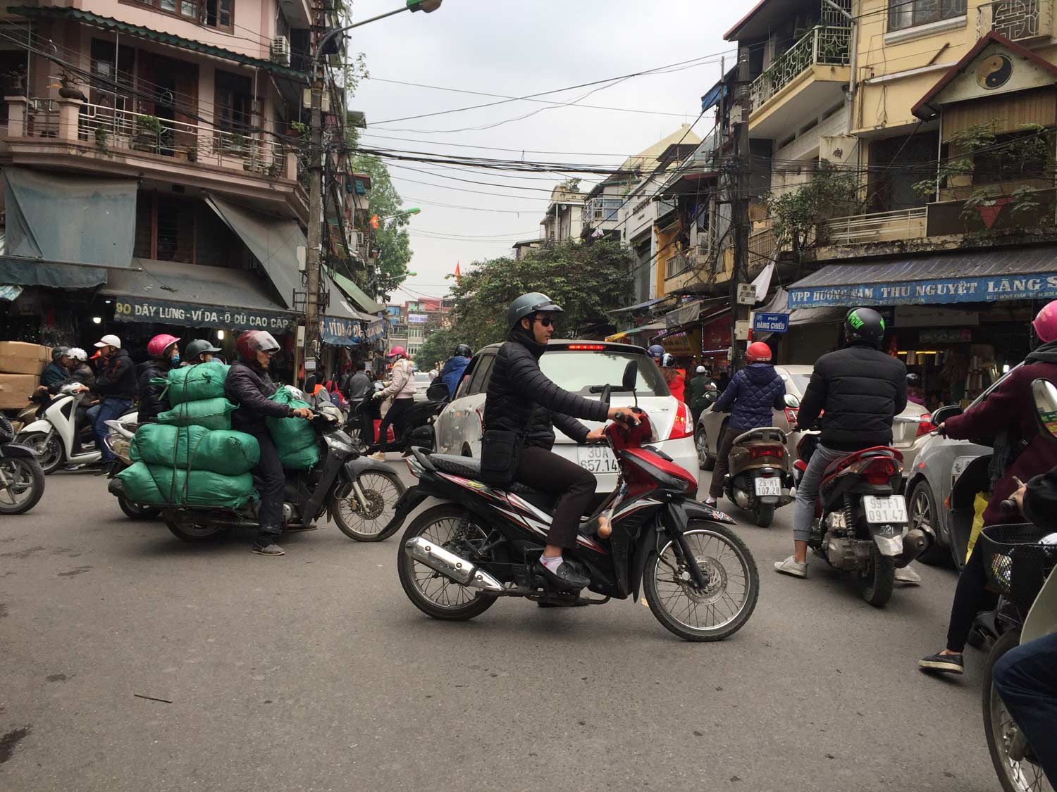 People Crossing Street In The Busy Streets Of Hanoi, Vietnam Stock